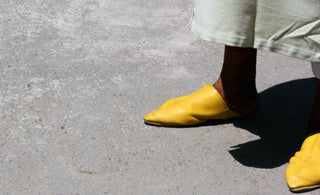 A person wearing yellow shoes