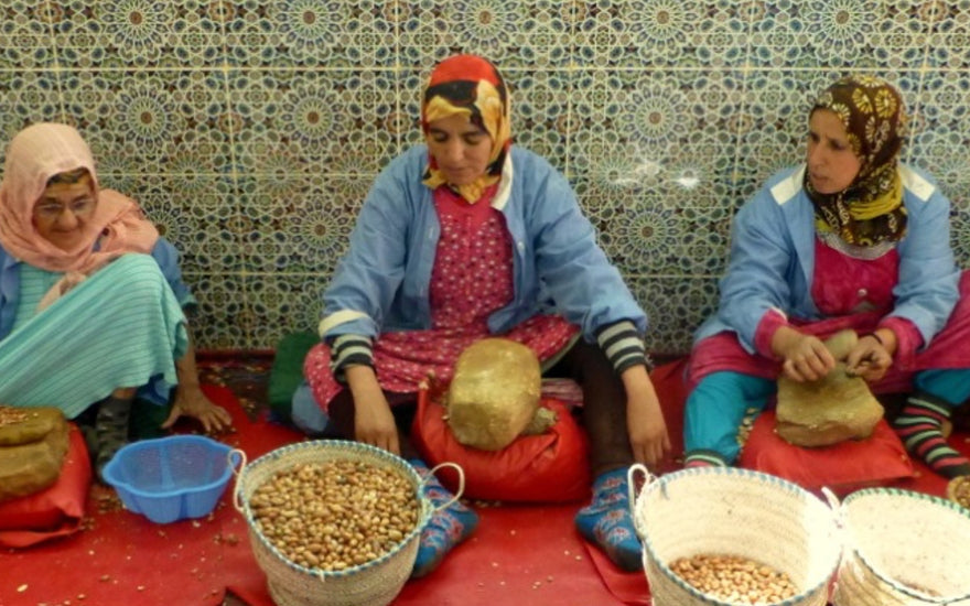 A group of women sitting on the floor with food