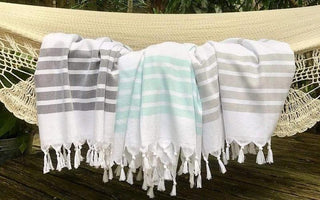 A group of white and grey striped towels on a hammock