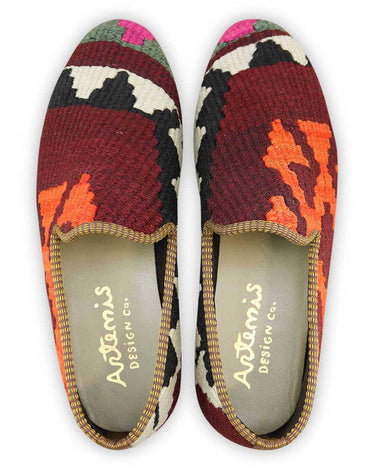 Artemis Shoes presents its men's loafers featuring a captivating color combination. The classic black offers timeless sophistication, while the clean white adds a crisp and versatile touch. The maroon hue adds a touch of richness and elegance, complemented by the dark grey for a sleek and refined look. The fuschia pink injects a vibrant pop of personality, while the orange adds a bold and energetic accent. (Front View)