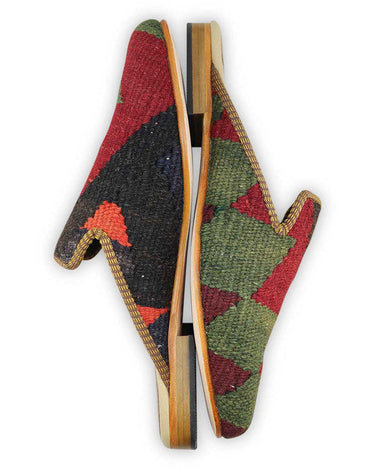 The Artemis Men's Slippers feature an intriguing color combination of moss green, maroon, black, red, orange, and brown. These slippers offer a mix of earthy and vibrant tones, creating a stylish and eye-catching look. Whether you're unwinding at home or stepping out for a casual outing, these slippers are the perfect choice. (Side View)