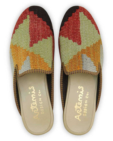 The Artemis Men's Slippers showcase a captivating color combination of black, lilac, red, green, white, grey, and mustard. These slippers offer a lively mix of bold and subtle tones, creating a stylish and eye-catching look. (Front View)