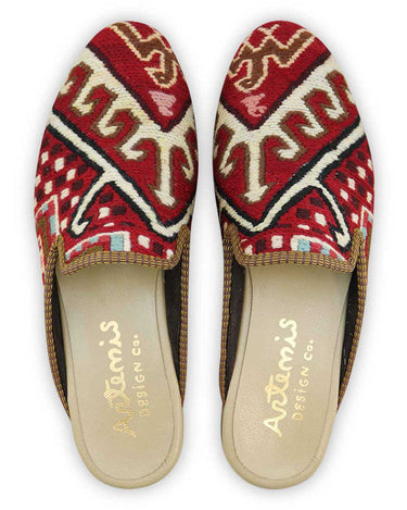 These slippers are designed to catch attention with their vibrant colors and contemporary style. The bold red and white hues create a visually pleasing contrast, while the touches of brown and pink add a subtle and unique twist. (Front View)